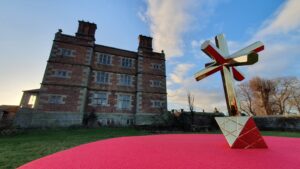The octahedral "IN HOC SIGNO" at Soulton Hall: Imagine the lost pyramidal roof above to understand how the building and the art share a common geometric language.