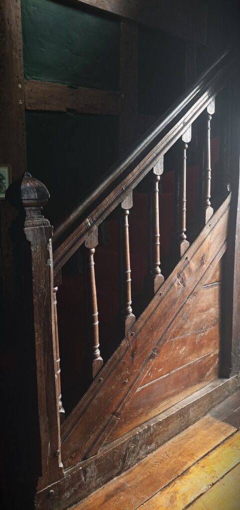 A closer view of the balusters and newel post of the 1550s Sir Rowland Hill Stairs at Soulton Hall