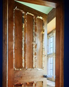 a door in the process of having champhers guilded 