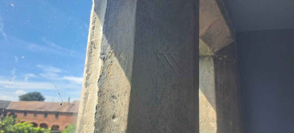 Barney Chevrons carved into the west window of the Hall Hall in Soulton Hall