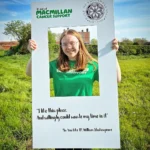 A volunteer for Macmillan Cancer, Ava, at the Shakespeare Bluebell Walk at Soulton Hall.