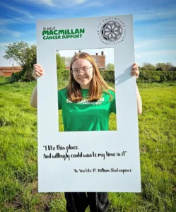 A volunteer for Macmillan Cancer, Ava, at the Shakespeare Bluebell Walk at Soulton Hall.