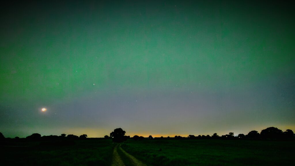 Northern Lights over Soulton Long Barrow - image by Guy Clarke