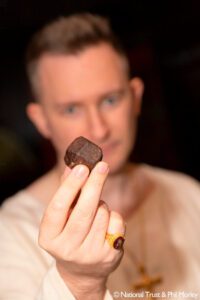 James Wenn with a garent stone (copyright Nationa Trust & Phil Morley)