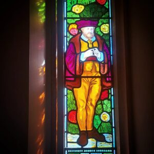 Stained Glass at the RSC showing the Seven Ages of Man: And then the justice, In fair round belly with good capon lin’d, With eyes severe and beard of formal cut, Full of wise saws and modern instances; And so he plays his part.