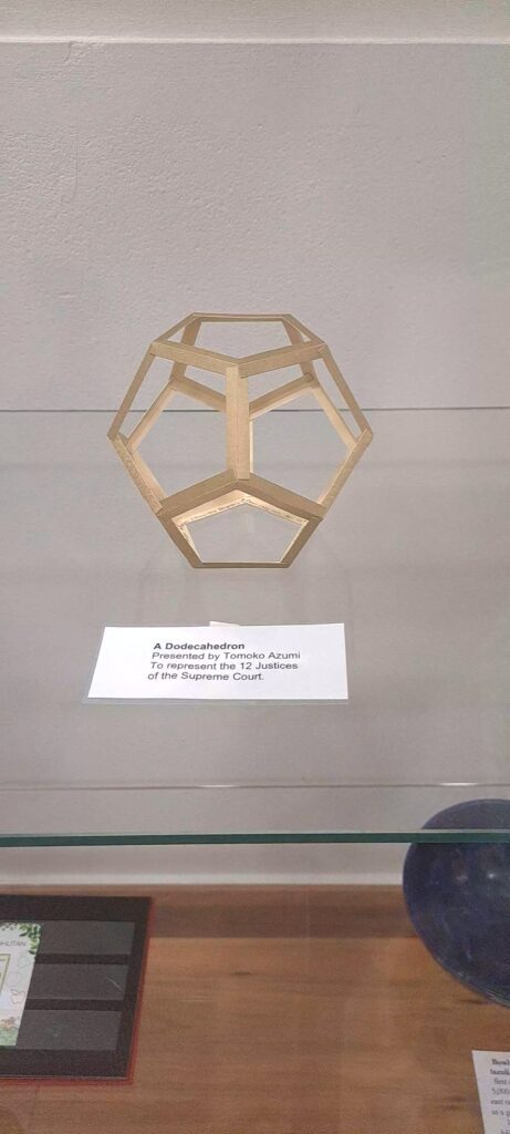 Among the displayed gifts to the court: a dodecahedron, representing the 12 Justices.