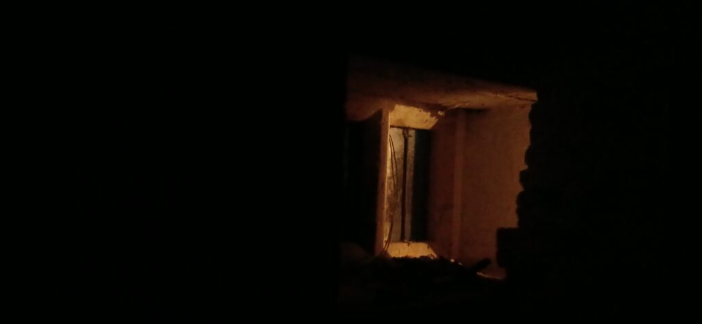 The lingering light: a reminder of the Harrowing of Hell and the promise of resurrection, emanating from the hidden candle in the aedicuale.