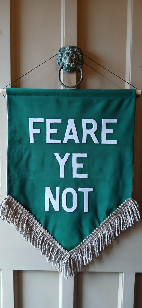 Banner reading FEARE YE NOT hung on main door