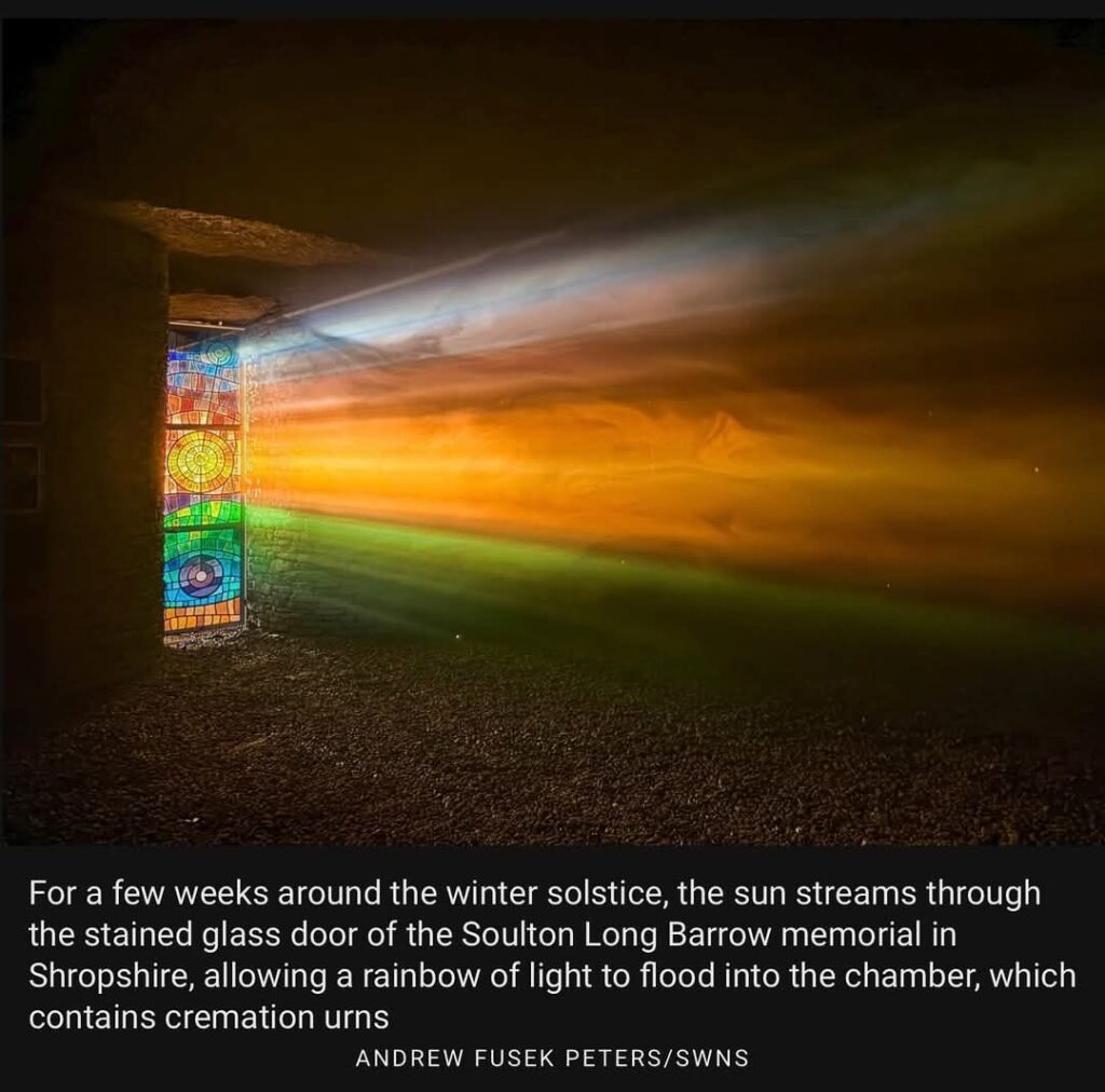 Photographer Andrew Fusek Peters captured this breathtaking scene at Soulton Long Barrow. The winter solstice sunbeams create a mesmerizing rainbow through the stained-glass window.