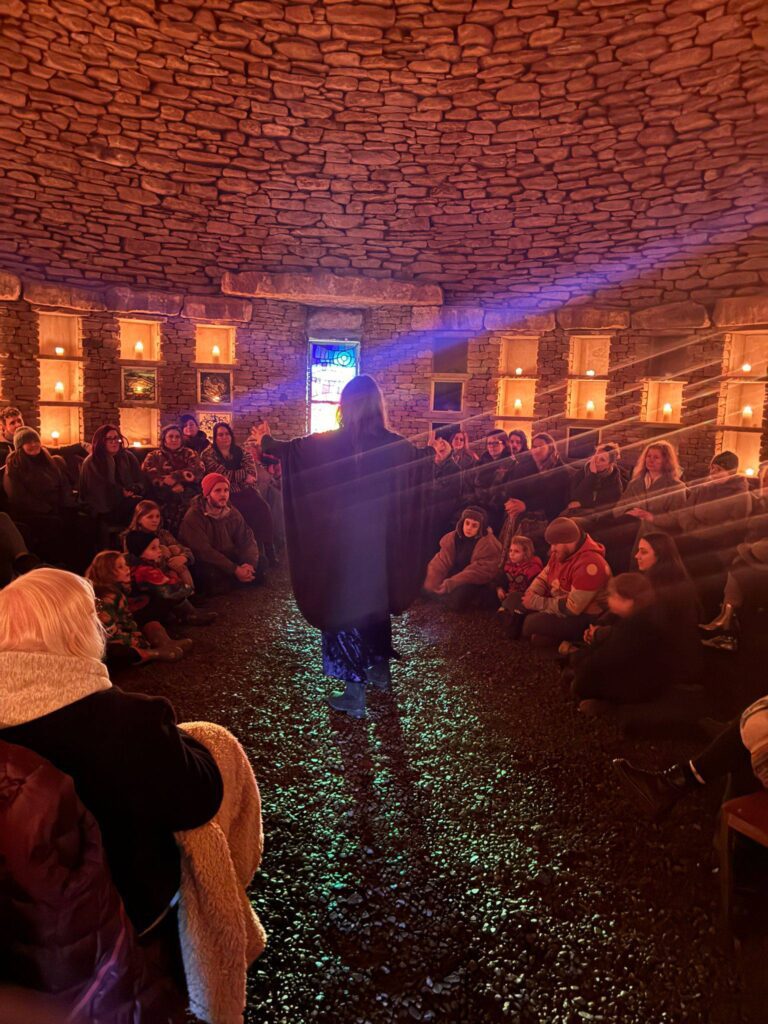 Intimate moments of storytelling, framed by the raw texture of the barrow’s inner walls at Soulton Long Barrow Winter Solstice Event 2025