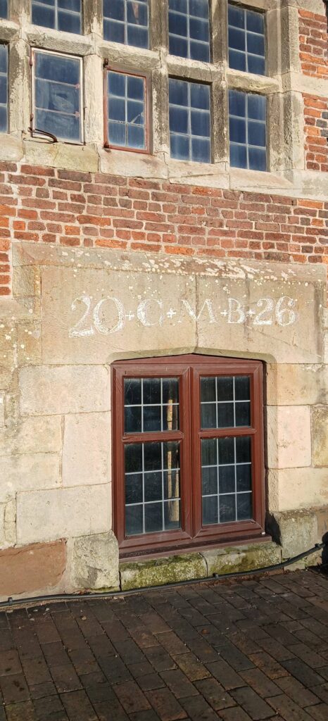 Epiphany maked in chalk over a 'lost' door constructed 1550s, turned into a window 1660s(?)