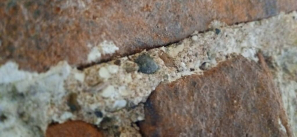 If you look closely at the mortar joints in the undercroft—either side of the bricked up door of the antichapel to the aedicule—you’ll notice a rugged, "bony" texture. This isn't your standard modern mortar; it is a primary document of Soulton’s birth.