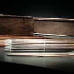 The recovered arrow shafts serve as stark reminders of the lethal conflict the ship was built to engage in, embodying the brutal reality of naval warfare and the constant, mechanical preparation for battle required by those on board.