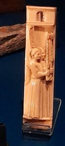 This carved bone panel, a work of Venetian craftsmanship likely over 100 years old when the ship sank, depicts two angels in a reverent procession bearing candles to symbolize the light of the divine, serving as a cherished heirloom that offered its owner a sense of spiritual constancy at sea.