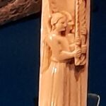 This carved bone panel, a work of Venetian craftsmanship likely over 100 years old when the ship sank, depicts two angels in a reverent procession bearing candles to symbolize the light of the divine, serving as a cherished heirloom that offered its owner a sense of spiritual constancy at sea.