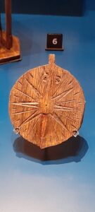 The small compass rose, incised onto a wooden fob, reflects the essential tools that were as familiar to the day-to-day work of a merchant as they were to a sailor at sea.