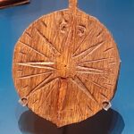 The small compass rose, incised onto a wooden fob, reflects the essential tools that were as familiar to the day-to-day work of a merchant as they were to a sailor at sea.